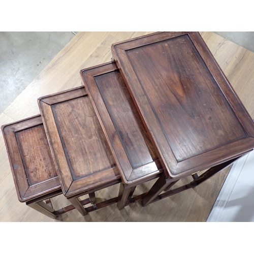 633 - A Nest of four Chinese hardwood Coffee Tables with recessed tops, shaped side rails and fluted legs ... 