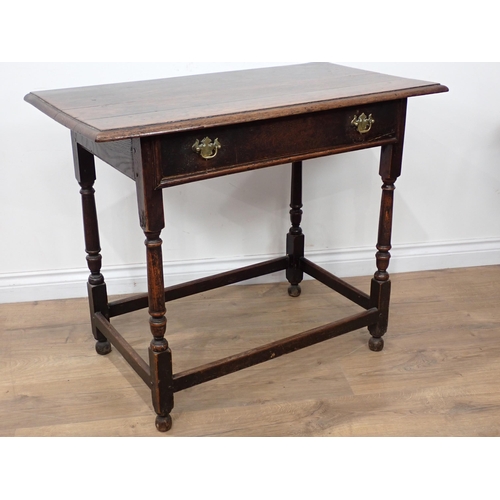 634 - An 18th Century oak Side Table with moulded top, fitted frieze drawer on turned and squared supports... 