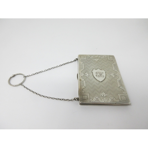 64 - A Victorian silver Card Case with floral engraving and shield cartouche, engraved initials, carrying... 