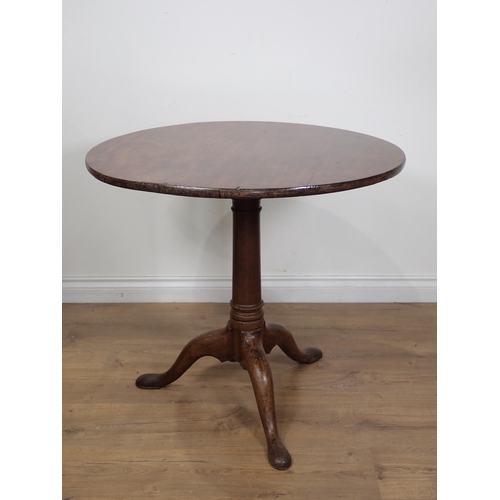 643 - A Georgian mahogany tilt-top Table with single piece top on gun barrel column on tripod base and pad... 