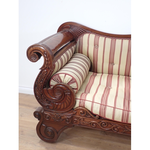 646 - A Regency carved mahogany Settee, the outswept arms and bowed ends above shaped supports and drop-in... 