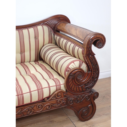 646 - A Regency carved mahogany Settee, the outswept arms and bowed ends above shaped supports and drop-in... 