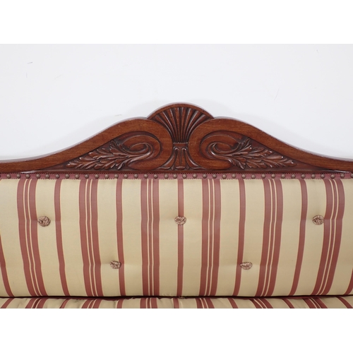 646 - A Regency carved mahogany Settee, the outswept arms and bowed ends above shaped supports and drop-in... 