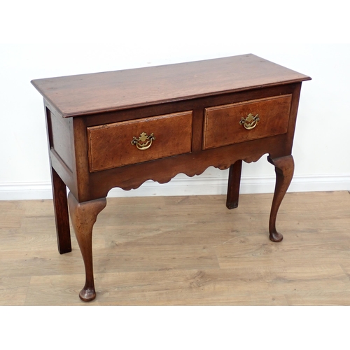 647 - An oak Dresser Base of small dimensions, the moulded top above a pair of drawers and shaped frieze, ... 