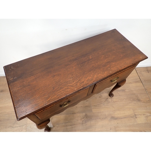 647 - An oak Dresser Base of small dimensions, the moulded top above a pair of drawers and shaped frieze, ... 