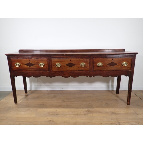 650 - An 18th Century fruitwood Dresser Base fitted with three mahogany crossbanded drawers above Cupid's ... 