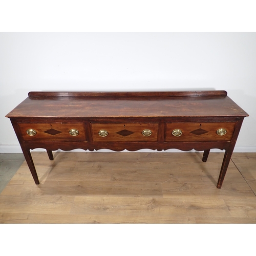 650 - An 18th Century fruitwood Dresser Base fitted with three mahogany crossbanded drawers above Cupid's ... 