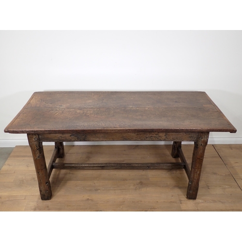 651 - An antique oak small Refectory Table with cleated thick two-plank top on chamfered square legs unite... 