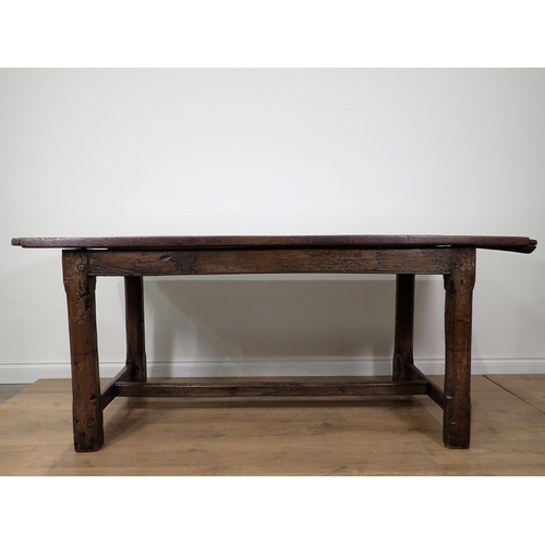 651 - An antique oak small Refectory Table with cleated thick two-plank top on chamfered square legs unite... 