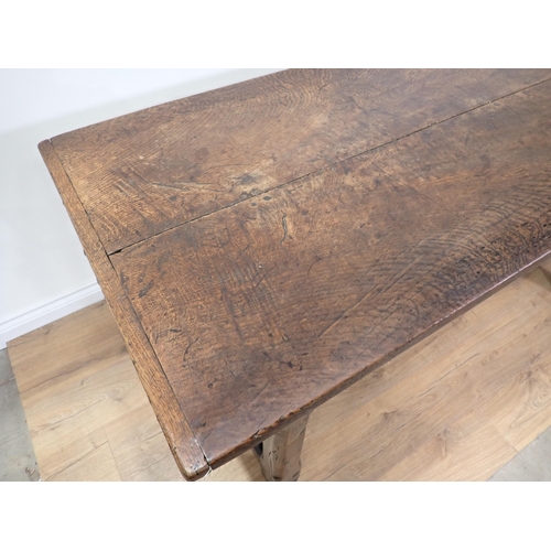 651 - An antique oak small Refectory Table with cleated thick two-plank top on chamfered square legs unite... 