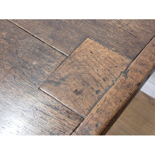 651 - An antique oak small Refectory Table with cleated thick two-plank top on chamfered square legs unite... 