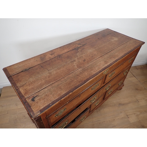 652 - A 19th Century oak Lancashire Chest with crossbanded hinged top above two dummy drawers above one lo... 