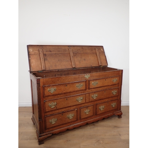 652 - A 19th Century oak Lancashire Chest with crossbanded hinged top above two dummy drawers above one lo... 