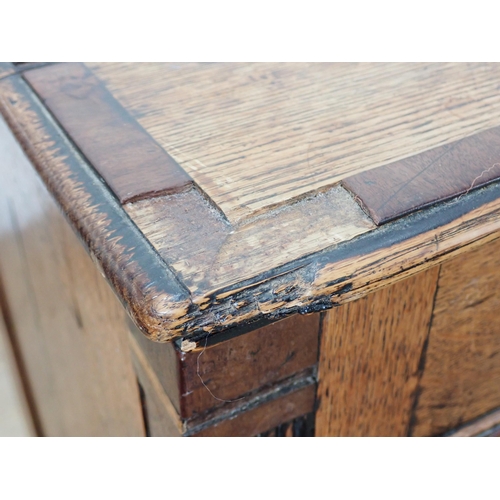 652 - A 19th Century oak Lancashire Chest with crossbanded hinged top above two dummy drawers above one lo... 