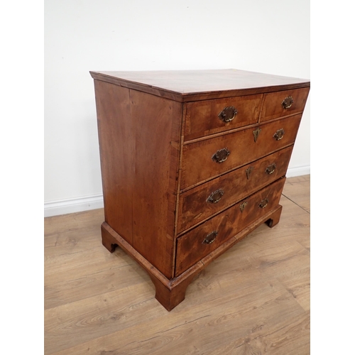 655 - An 18th Century walnut Chest of Drawers, the double crossbanded quartered top above 2 short and thre... 