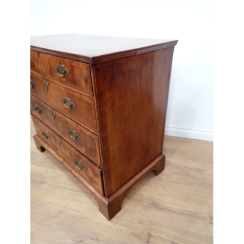 655 - An 18th Century walnut Chest of Drawers, the double crossbanded quartered top above 2 short and thre... 