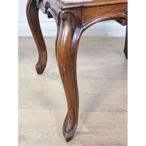 656 - A Victorian walnut Dressing Stool with upholstered top on cabriole supports with carved scroll edges... 