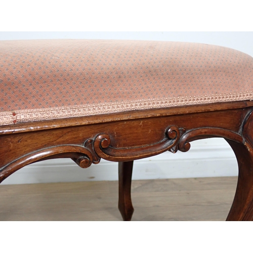 656 - A Victorian walnut Dressing Stool with upholstered top on cabriole supports with carved scroll edges... 