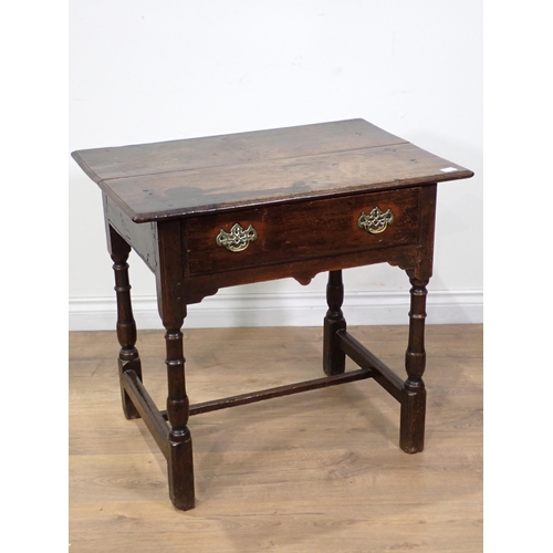 658 - An early 18th Century oak Side Table with moulded top fitted frieze drawer above a shaped frieze on ... 