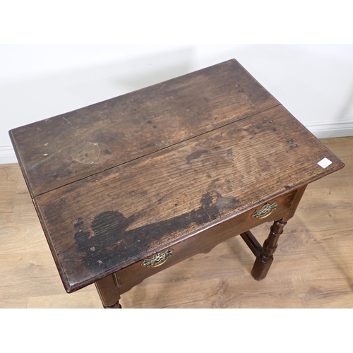 658 - An early 18th Century oak Side Table with moulded top fitted frieze drawer above a shaped frieze on ... 