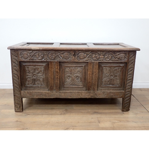 659 - A 17th Century oak Coffer with hinged panelled top carved frieze above three carved panels, 4ft 7½ i... 