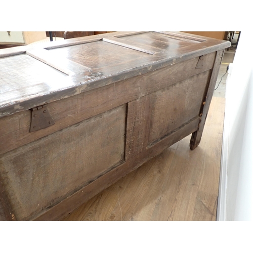 659 - A 17th Century oak Coffer with hinged panelled top carved frieze above three carved panels, 4ft 7½ i... 