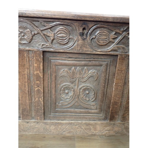 659 - A 17th Century oak Coffer with hinged panelled top carved frieze above three carved panels, 4ft 7½ i... 