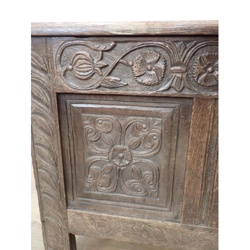 659 - A 17th Century oak Coffer with hinged panelled top carved frieze above three carved panels, 4ft 7½ i... 