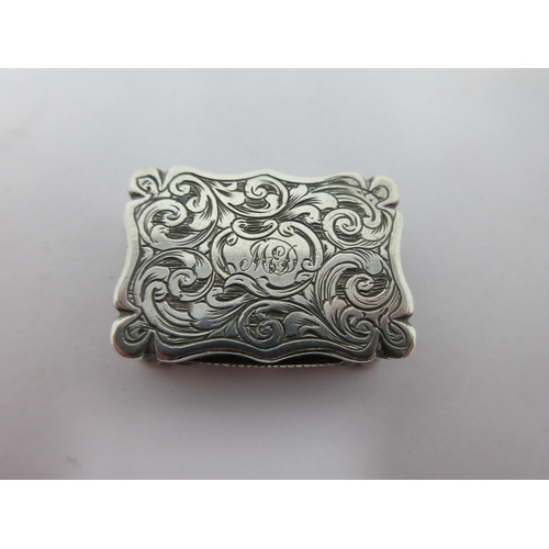 66 - A Victorian silver Vinaigrette with leafage scroll engraving and initials, scroll pierced grille, Bi... 