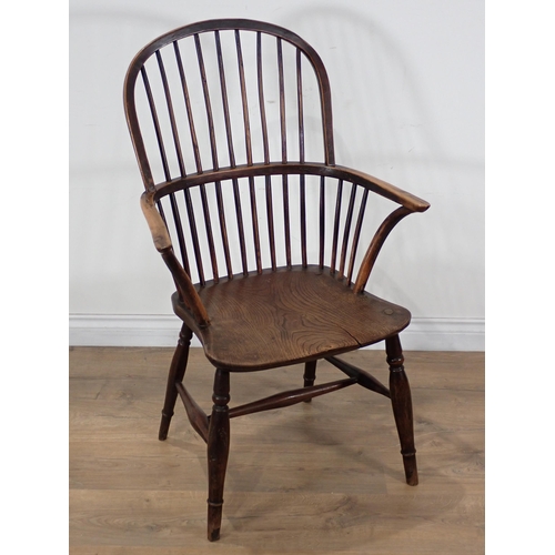 660 - A 19th Century yew wood and elm Windsor Armchair, the hoop back and bow arms above a moulded seat on... 