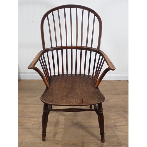 660 - A 19th Century yew wood and elm Windsor Armchair, the hoop back and bow arms above a moulded seat on... 