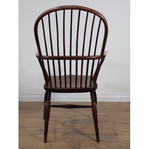 660 - A 19th Century yew wood and elm Windsor Armchair, the hoop back and bow arms above a moulded seat on... 