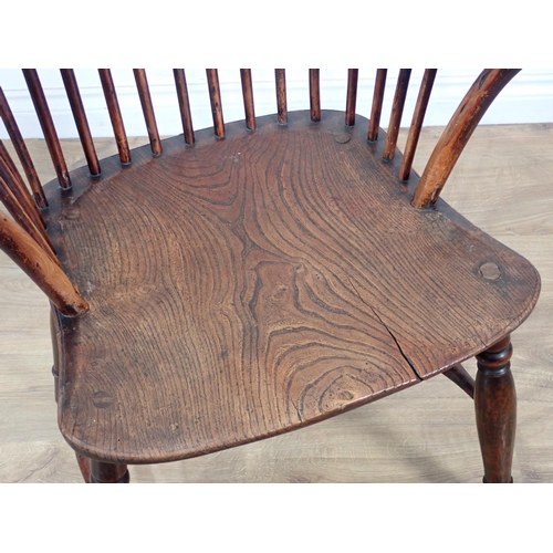 660 - A 19th Century yew wood and elm Windsor Armchair, the hoop back and bow arms above a moulded seat on... 