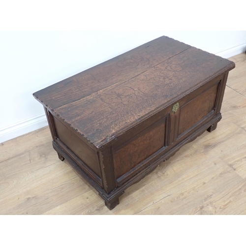 664 - A small 17th Century carved oak Coffer with moulded hinged top, panelled front above a shaped frieze... 