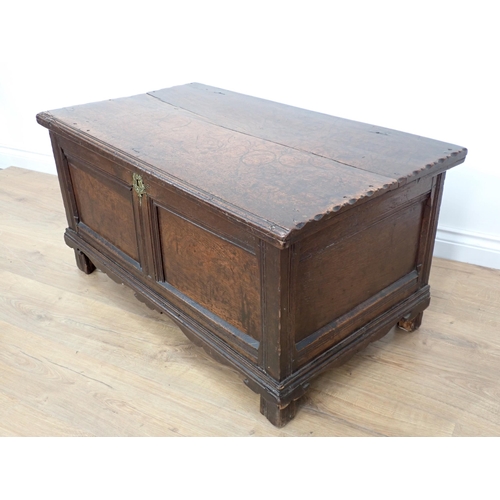 664 - A small 17th Century carved oak Coffer with moulded hinged top, panelled front above a shaped frieze... 