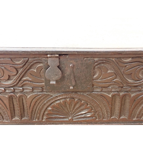 666 - A 17th Century oak Bible Box, the flat lid with chiselled edge, the front with scroll and luneete ca... 