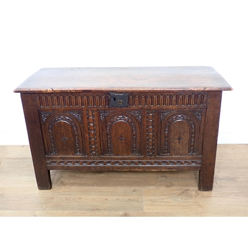 673 - A 17th Century oak small Coffer with plank lid above gouge carved frieze and three arch carved panel... 