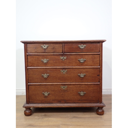 675 - An 18th Century oak Chest of drawers with moulded top above two short and three graduated long drawe... 