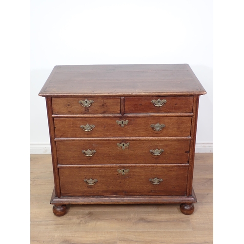 675 - An 18th Century oak Chest of drawers with moulded top above two short and three graduated long drawe... 