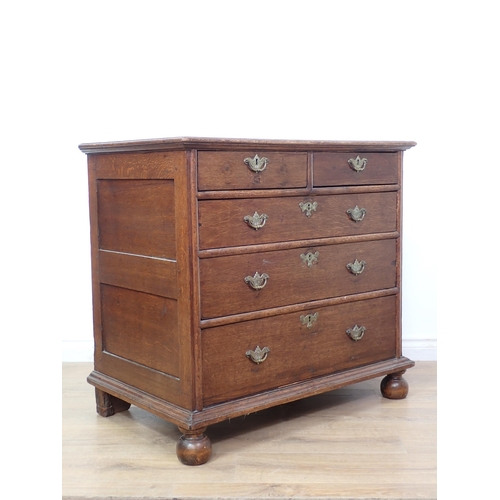 675 - An 18th Century oak Chest of drawers with moulded top above two short and three graduated long drawe... 