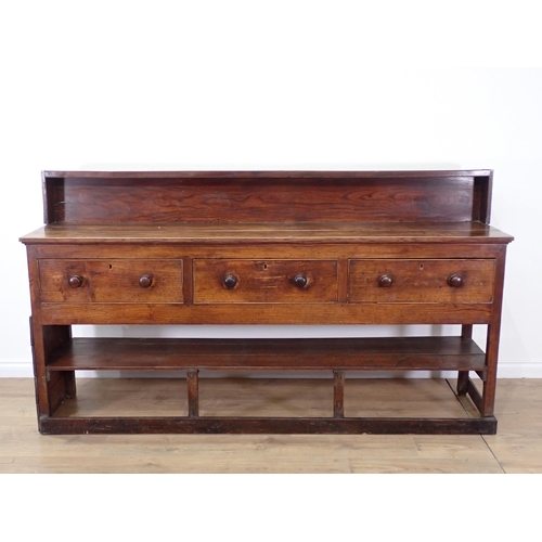 679 - An 18th Century elm Dresser Base fitted three frieze drawers with turned handles mounted upon square... 