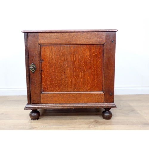 681 - A late 17th Century oak and elm Cupboard with single solid panelled door enclosing three drawers on ... 