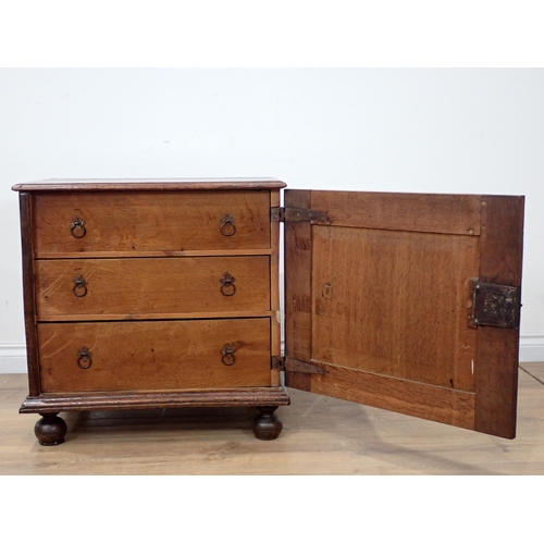 681 - A late 17th Century oak and elm Cupboard with single solid panelled door enclosing three drawers on ... 