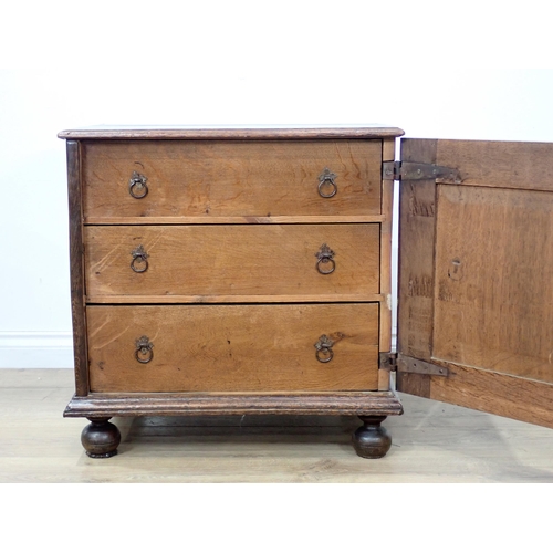 681 - A late 17th Century oak and elm Cupboard with single solid panelled door enclosing three drawers on ... 