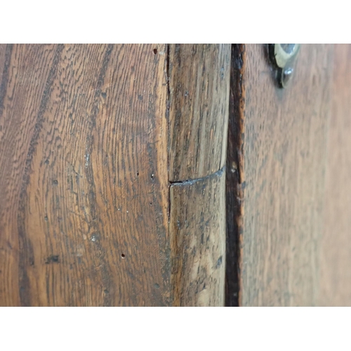 681 - A late 17th Century oak and elm Cupboard with single solid panelled door enclosing three drawers on ... 