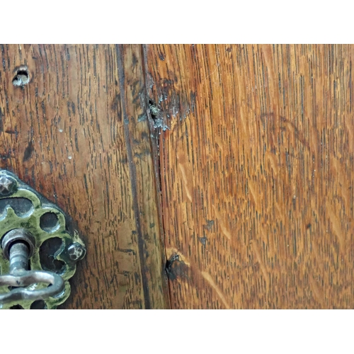 681 - A late 17th Century oak and elm Cupboard with single solid panelled door enclosing three drawers on ... 