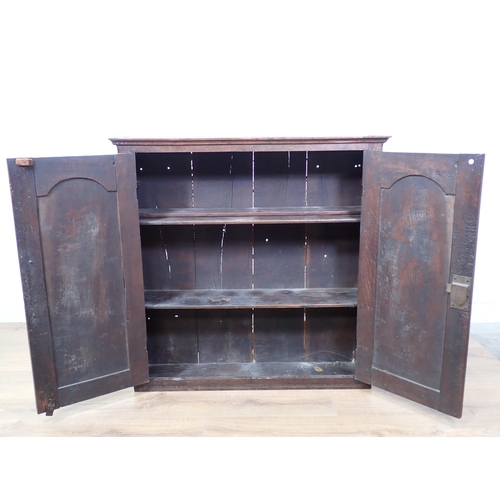 686 - An 18th Century oak Cupboard fitted pair of fielded arched panel doors enclosing shelves 3ft 2in W x... 