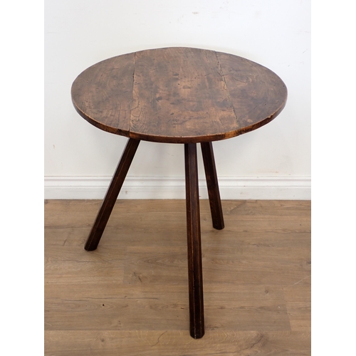 687 - An antique elm circular Cricket Table on three splayed octagonal stick legs 2ft 1 1/2in H x 2ft D