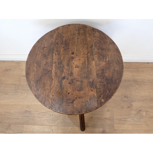 687 - An antique elm circular Cricket Table on three splayed octagonal stick legs 2ft 1 1/2in H x 2ft D