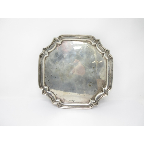 69 - A George V silver shaped square Salver on four hoof feet, Birmingham 1932, 680 gms